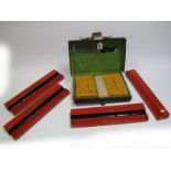 A Circa 1920's Mahjong Set, the stained ivorine tiles contained in a fitted leather attache style