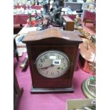 An Edwardian Mahogany Cased Mantel Clock, having arched top over circular dial with Arabic