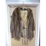 A Three-quarter Length Mink Coat, light brown, 82cms long; plus a cream mink stole, four tail