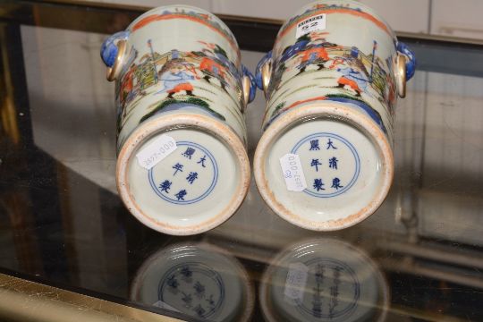 A pair of Chinese famille rose ceramic vases, decorated with multi coloured figures in foliage on - Image 5 of 5