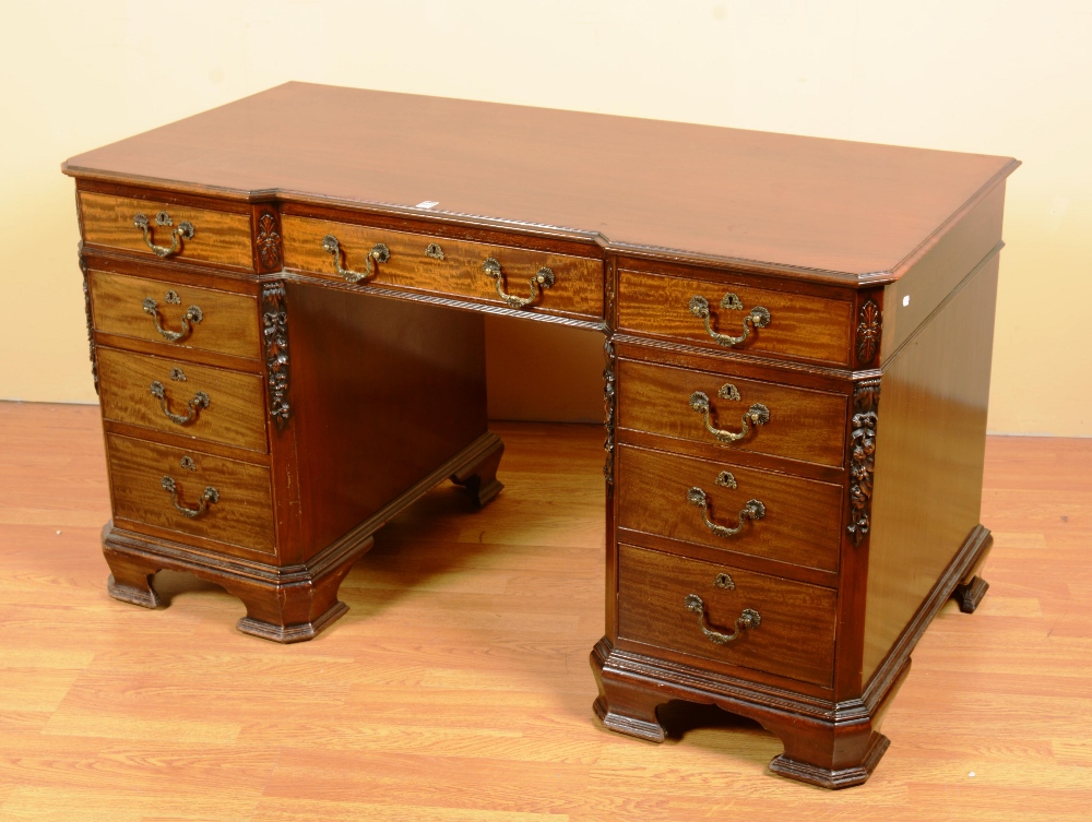 A mahogany kneehole desk, with three fit
