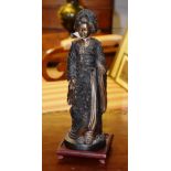 A Japanese bronzed Geisha figure, on a s