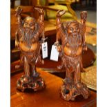 A pair of Oriental hardwood figures, pos