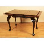 A mahogany pullout dining table, raised