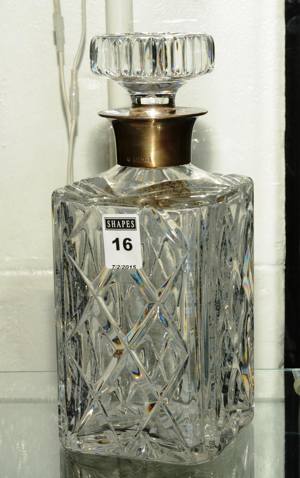 A silver necked crystal decanter, bearin