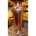 An Art Nouveau hammered copper vase deco