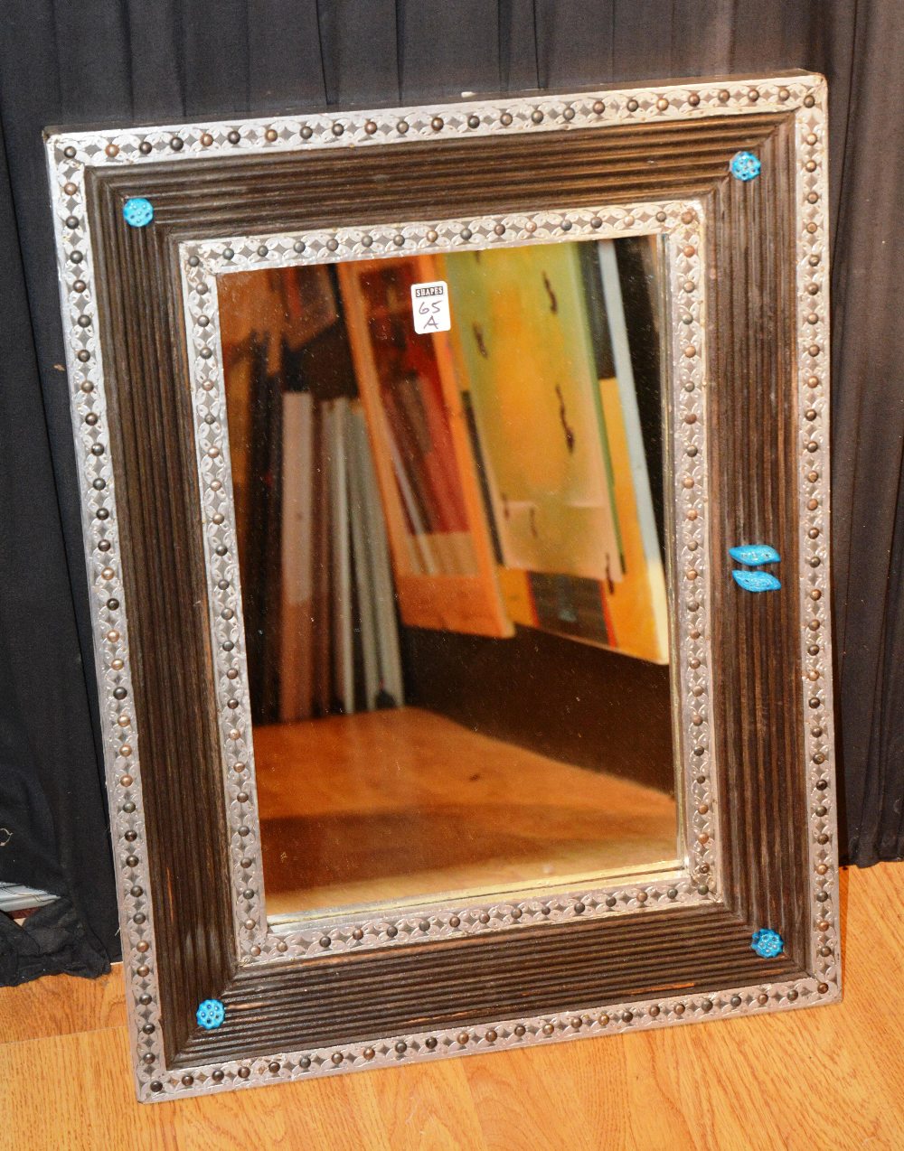 An Indian silvered wall mirror, decorate