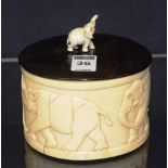 A 19th century Chinese ivory casket, the oval wood lid with elephant finial, the box decorated