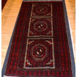 A Persian rug, with three gul panels ove