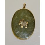 A 14ct gold and jade type pendant, with