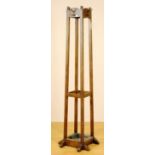 An oak hat and coat stand, with fitted hooks above a stick stand recess and dust pan, 186cm high