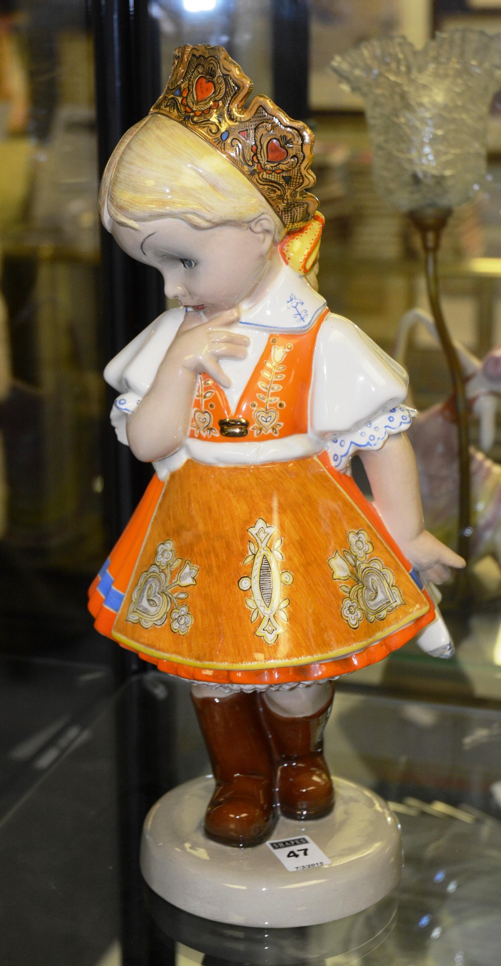 A glazed ceramic figure of a girl, by CI