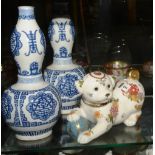 A pair of 20th century Chinese blue and white pottery vases, decorated with blue symbols on a