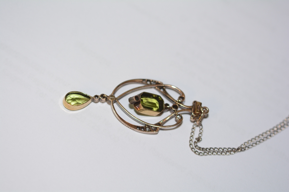 A yellow metal peridot and diamond pendant, the central emerald cut peridot drop (approx. 1.5ct) - Image 3 of 3