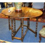 An oak gateleg table, with drop flaps, raised on bobbin twist supports and plain stretchers, 72cm