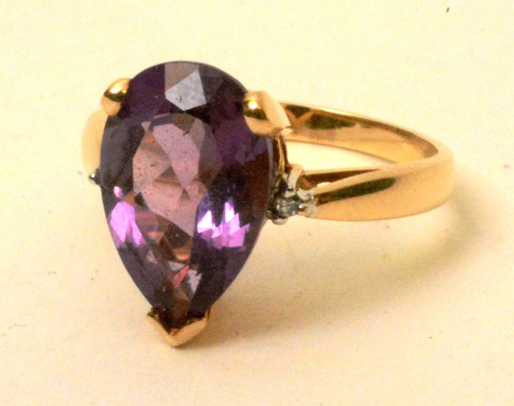 A yellow metal amethyst and diamond ring