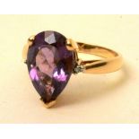 A yellow metal amethyst and diamond ring