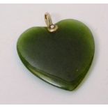 A yellow metal and jade style heart shap