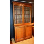 A late Victorian oak glazed two door bookcase, with moulded cornice above two glazed astragal doors,