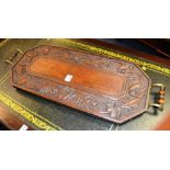 A carved wood serving tray, decorated wi
