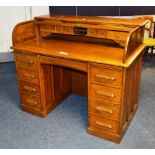 An oak roll top desk, the top with tambo