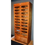 A vintage oak shop haberdashery unit, with ten pull out drawers to each side (some glazed), ending