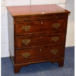 A George II style mahogany chest of drawers, of small proportions, with pull out slide above three