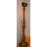 A gilt painted floor lamp, raised on ree