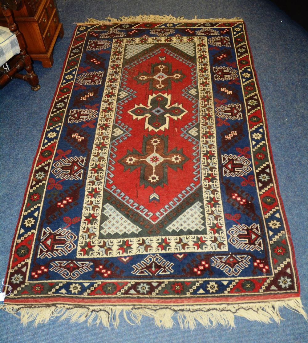 A Persian rug, with triple cruciform ove