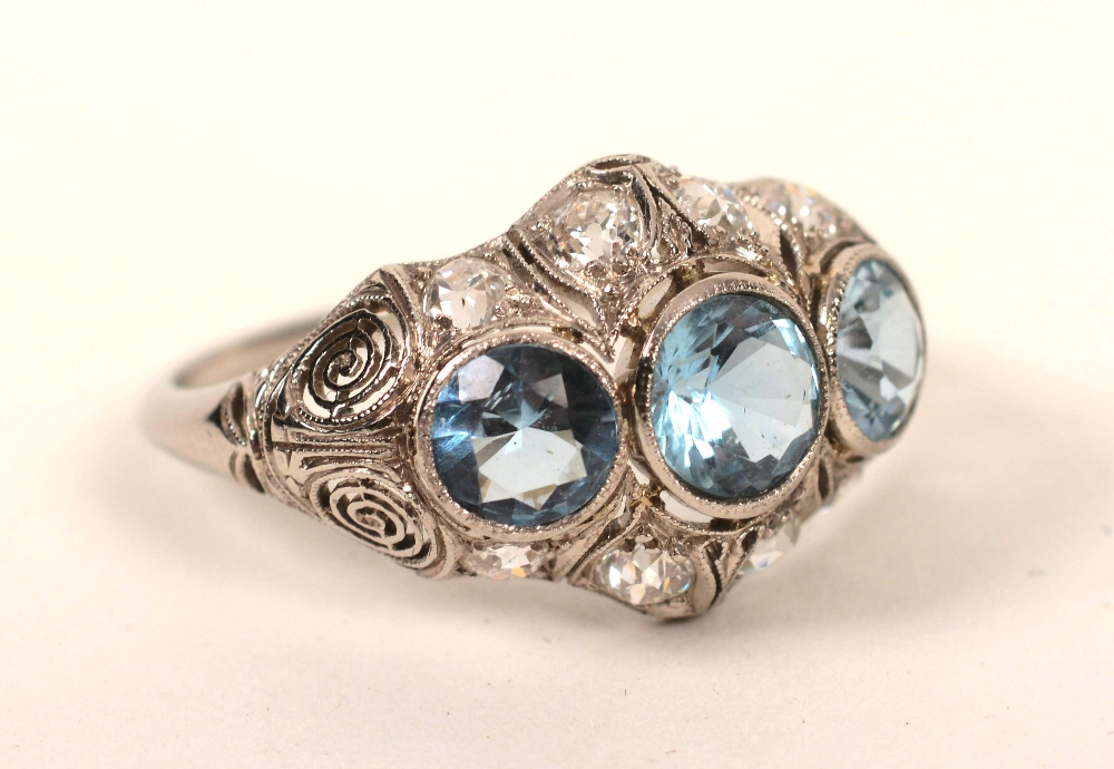 A white metal aquamarine and diamond ring,