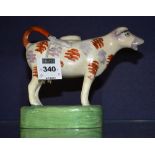 A 19th century Staffordshire pearlware cow creamer with cover,