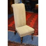 A Victorian rosewood prie dieux, upholstered in brown floral fabric, raised on turned supports,