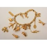 An 18ct gold charm bracelet, including further loose charms, 34.