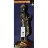 A Thai metal figure of a Buddha, raised on wooden stand,