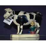 A 19th century Staffordshire pearlware cow creamer, with black sponged decoration to body,