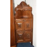 A carved oak corner cupboard, in the Jacobean style,