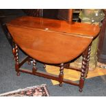 A mahogany gateleg dining table, raised on spiral column supports and plain under stretchers,