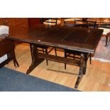 A pull out dining table, raised on splat supports,