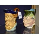 Two sarreguemines character jugs, one jug double faced, both richly glazed in blue, brown and green,