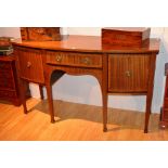 An Edwardian mahogany crossbanded sideboard, with central drawer above open recess,