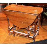 A small gateleg table, raised on turned supports and plain under stretchers, 75cm high,