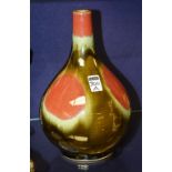 A Chinese Flambe two colour glazed pottery vase, in mottled green and red, 28cm high CONDITION