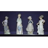 Four nao figures, comprising of boy with dog and three girl figures,