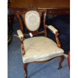 A pair of Edwardian mahogany open parlour armchairs, with carved shield shaped back rests,