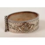 A silver bangle commemorating Queen Victoria's Diamond Jubilee, with crown jubilee decoration to