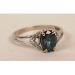 An 18ct white gold alexandrite and diamond ring, the central oval cut dark green alexandrite,