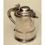 A silver water jug, marks worn, the turned lid with scroll handle,