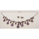 A white metal amethyst and seed pearl necklace, with 23 oval cut amethysts in drop formation