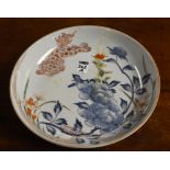 A Chinese Kakiemon style circular pottery dish, decorated with shi shi dragon in foliage, in blue,