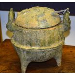 A Chinese Tang style terracotta bowl and cover, with ornate carry handles, glazed in green,